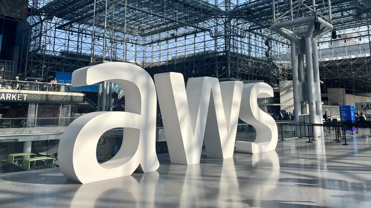 "AWS" letters in the center of a light-filled atrium