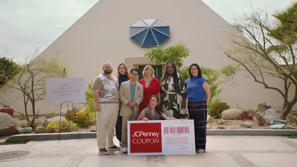 A group of people standing outside pose for a photograph.