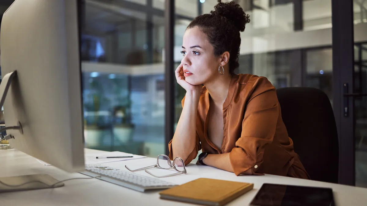 A person works on the computer in the office, late at night