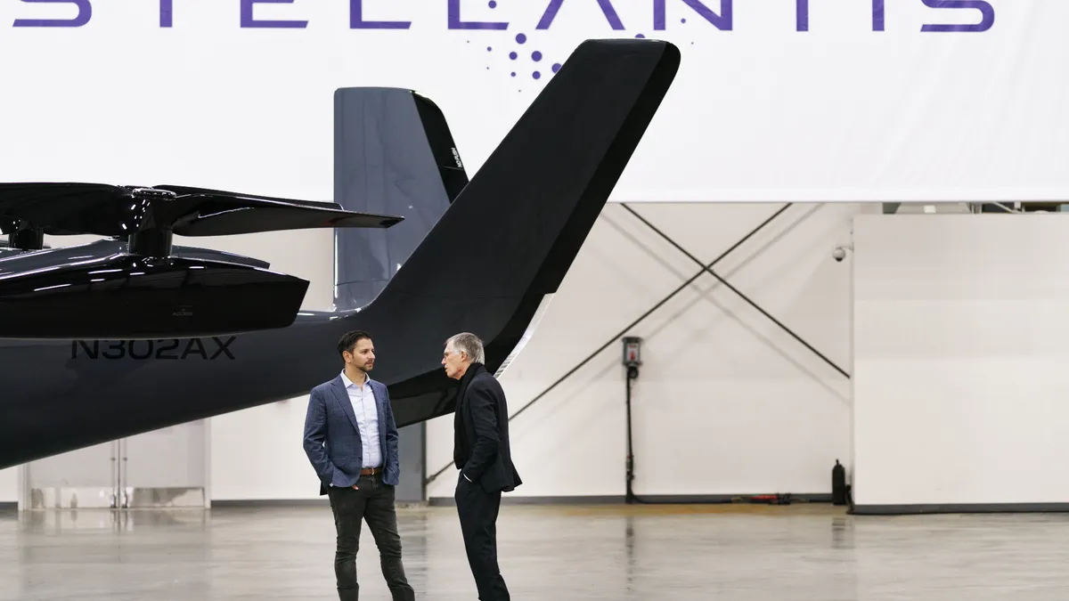 Pictured is Archer Aviation CEO Adam Goldstein (left) and Stellantis CEO Carlos Tavares with an Archer eVTOL aircraft in the background.