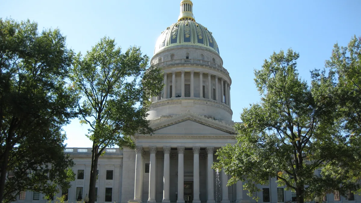 A fountain runs in front of the West Virginia state capitol building