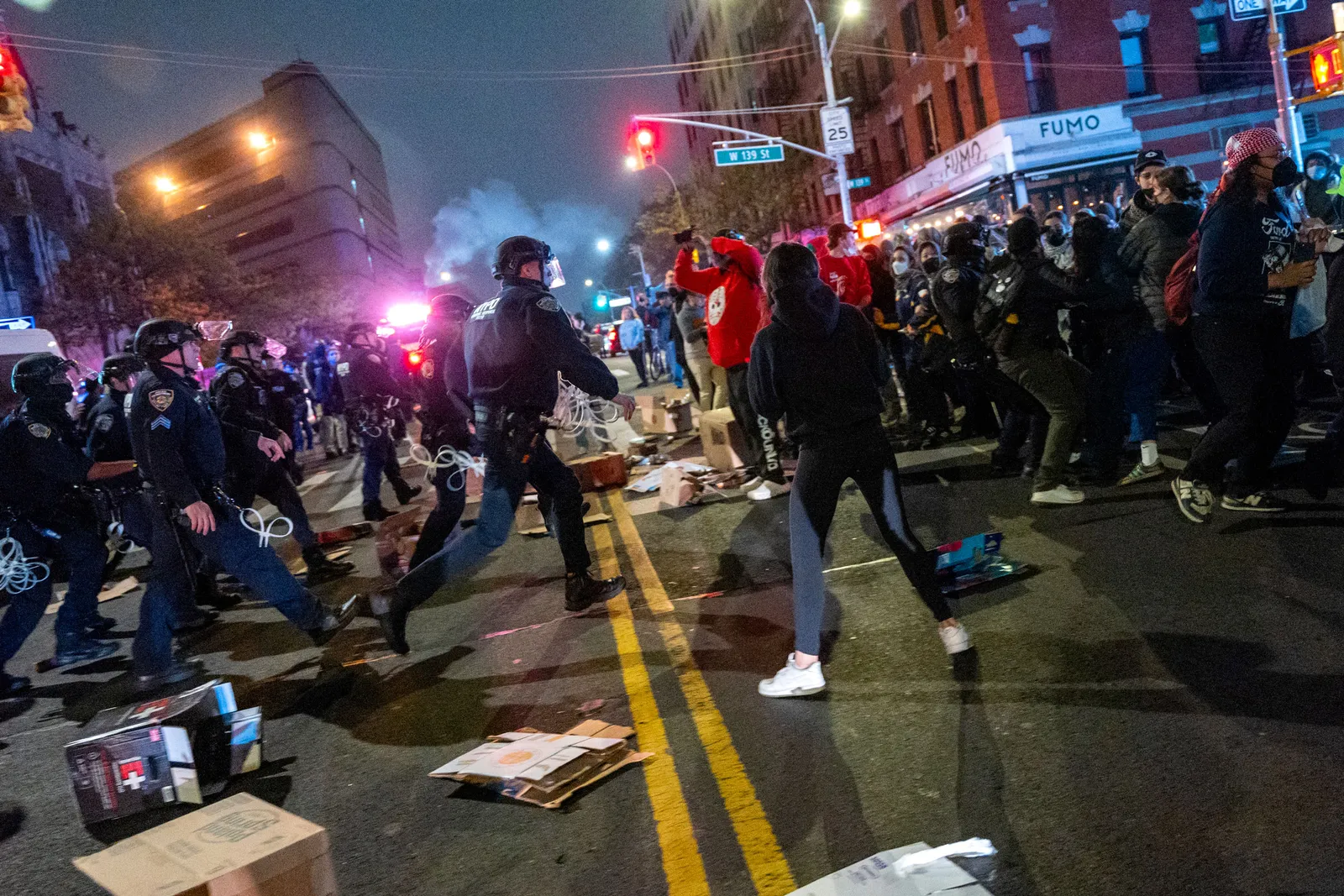 Police clash with protesters on the street during demonstrations at the City College of New York.