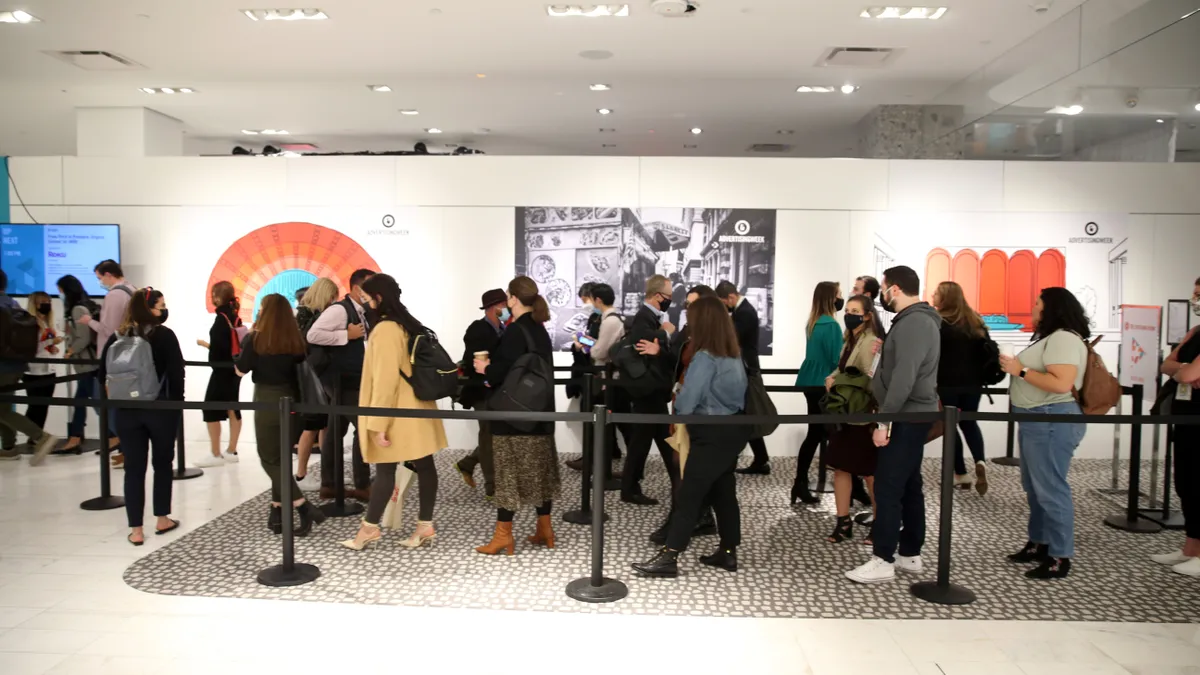 People wait in line at Advertising Week 2021. Retrieved by Marketing Dive on Oct. 25, 2021