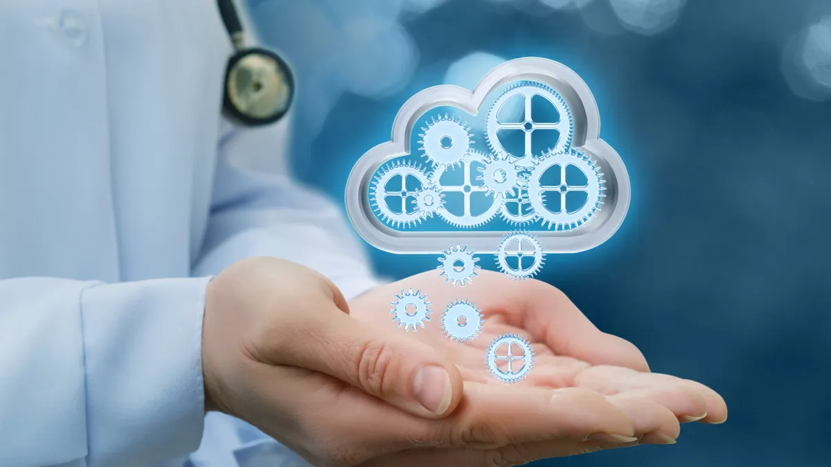 A doctor's hand cupped out with a digital cloud hovering over