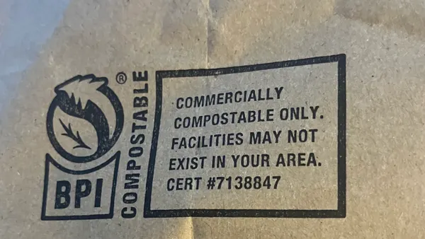 A brown bag bears a BPI compostable logo and says 'COMMERCIALLY COMPOSTABLE ONLY, FACILITIES MAY NOT EXIST IN YOUR AREA'