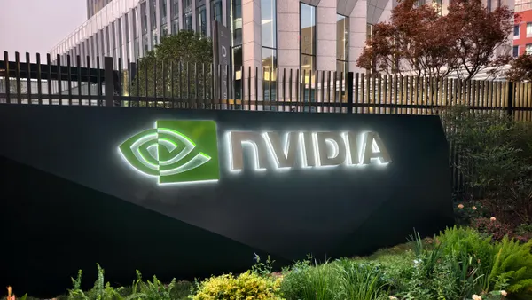 The Nvidia company brand logo on a sign in front of a modern office building.