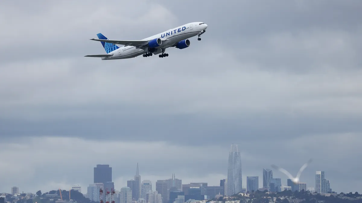 A United Airlines plane takes off from San Francisco International Airport in front of the San Francisco skyline on March 13, 2023 in San Francisco, California.