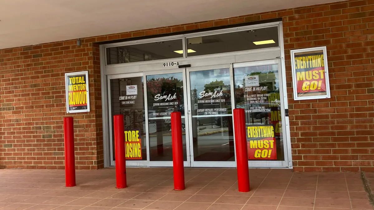 The front door of the Sam Ash Music store in Richmond, Virginia with store closing signs.