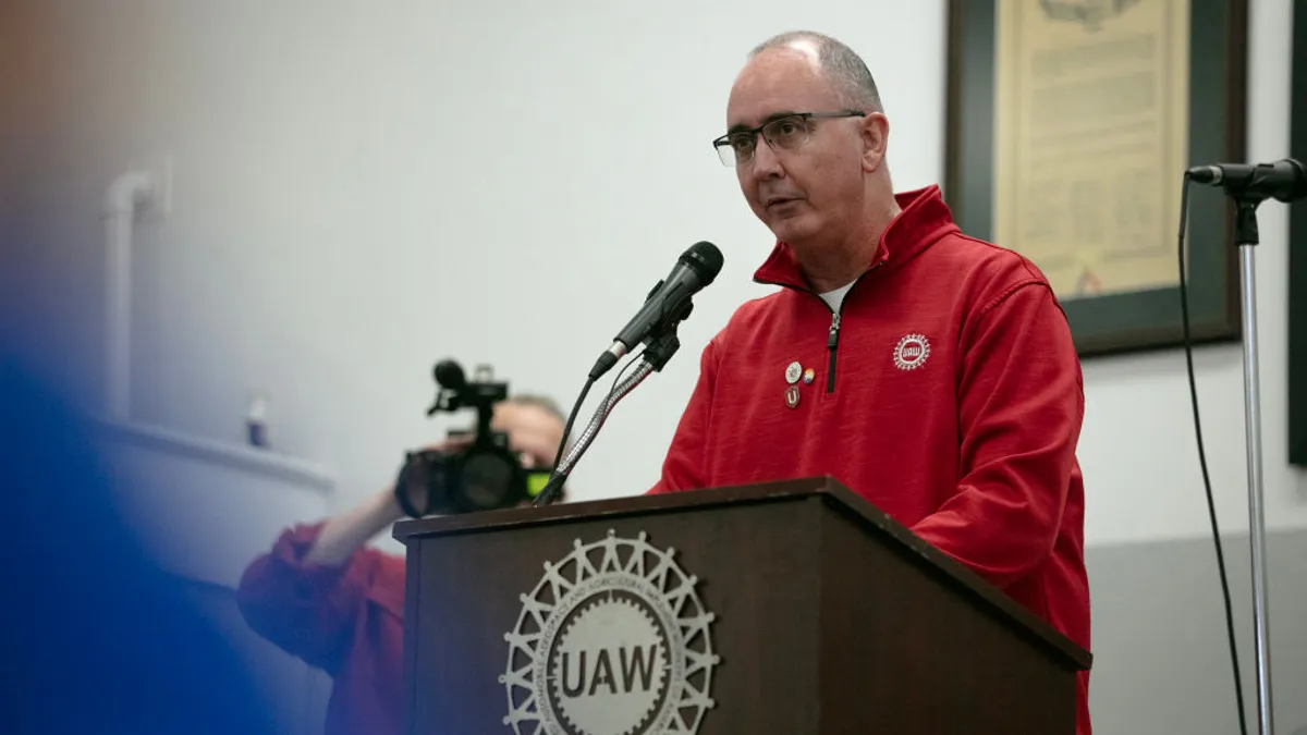 UAW President Shawn Fain speaks at a rally in a Chicago union hall.