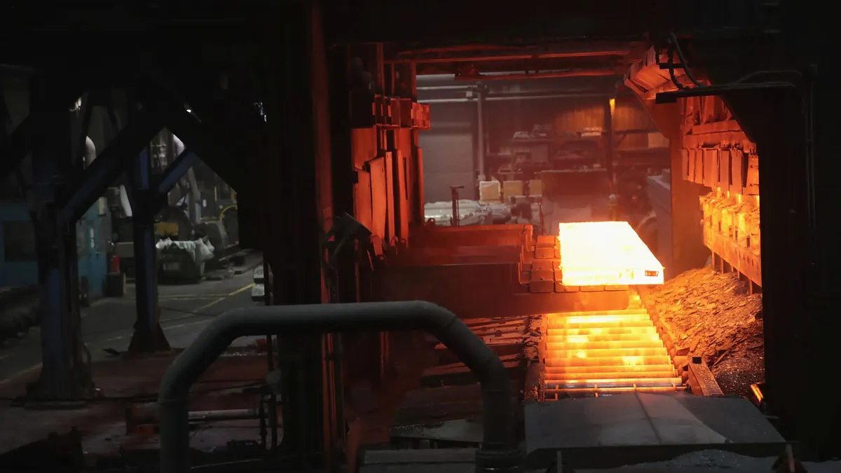 a hot slab of steel glows orange