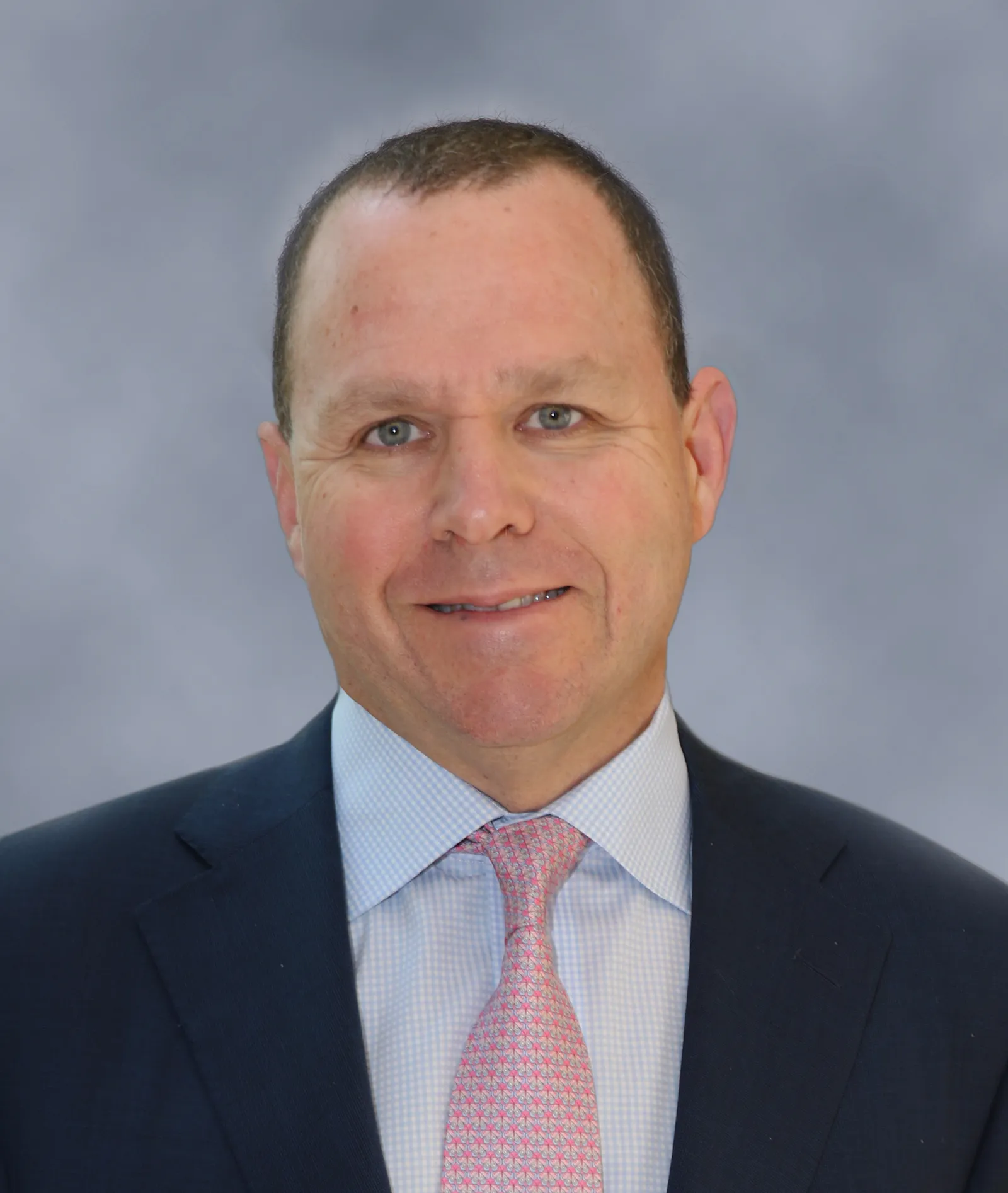 Man in dark suit and white shirt