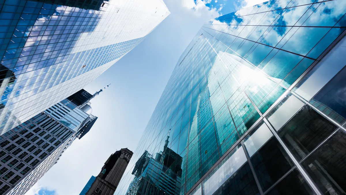 A view of blue toned high-rise buildings in New York City's Wall Street financial district.