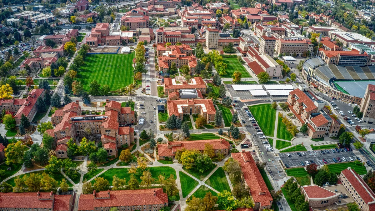 University fields and buildings are seen from above.