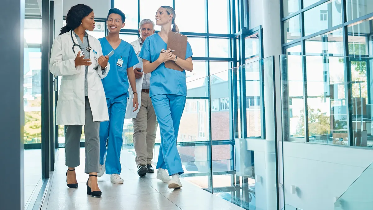 Four medical professionals walking