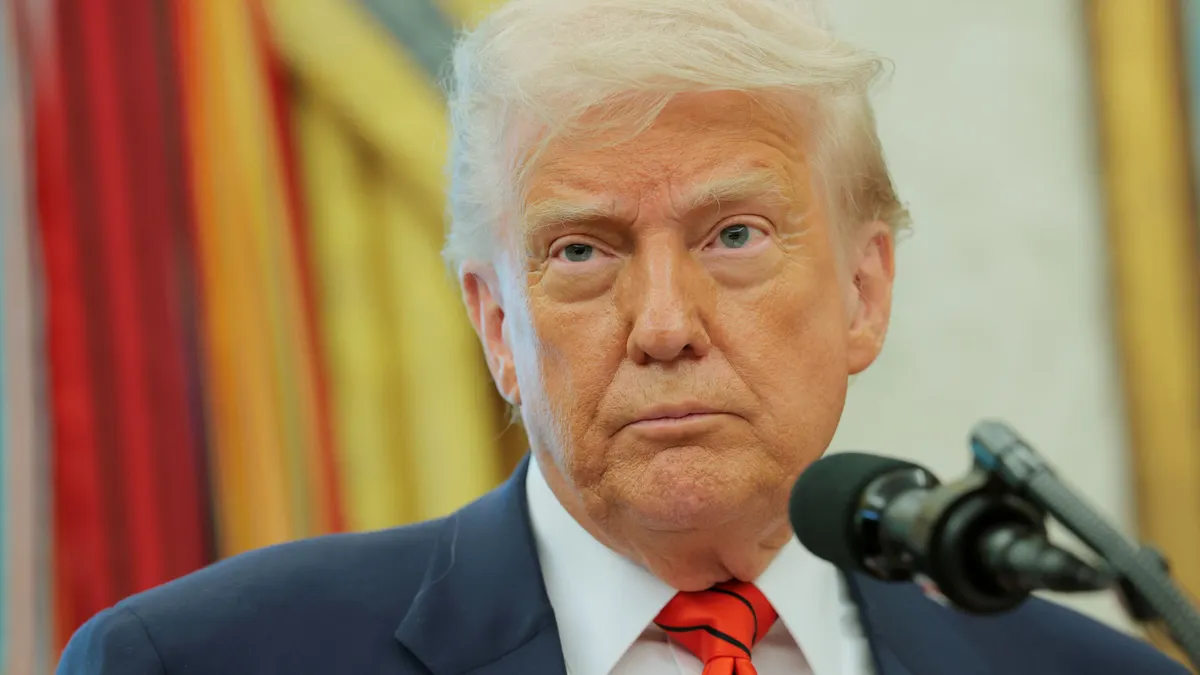 President Donald Trump stands at a podium in the White House on May 6, 2025.