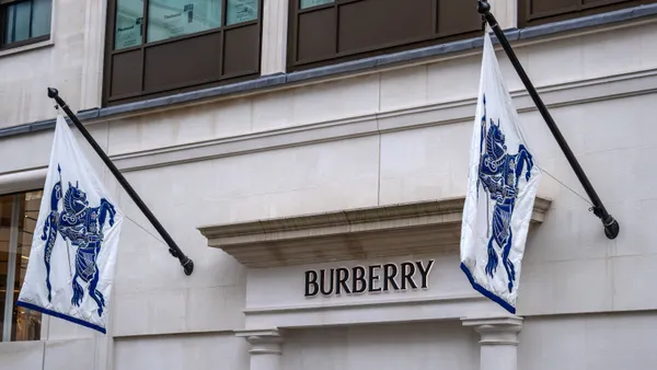 The exterior of a Burberry store features two flags displaying the brand's logos.