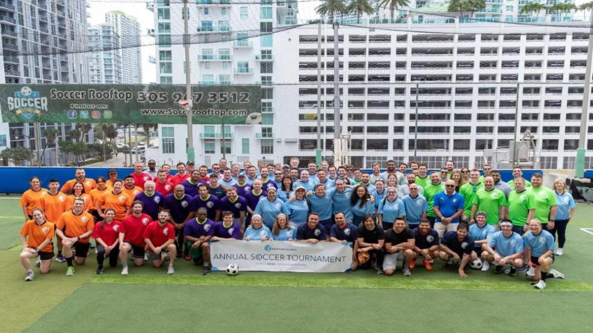 Group photo of American Global LLC employees at their annual soccer tournament