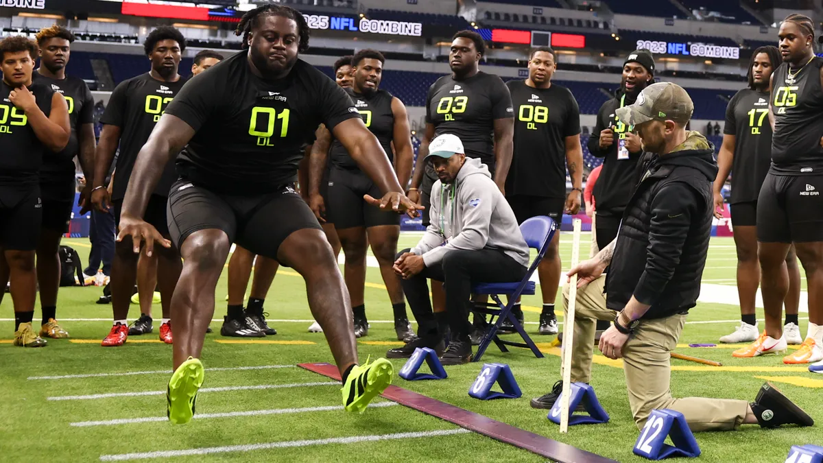 NFL Combine participants complete the broad jump drill during the first day of the skills showcase at Lucas Oil Stadium in Indianapolis, Indiana on Feb. 27, 2025.