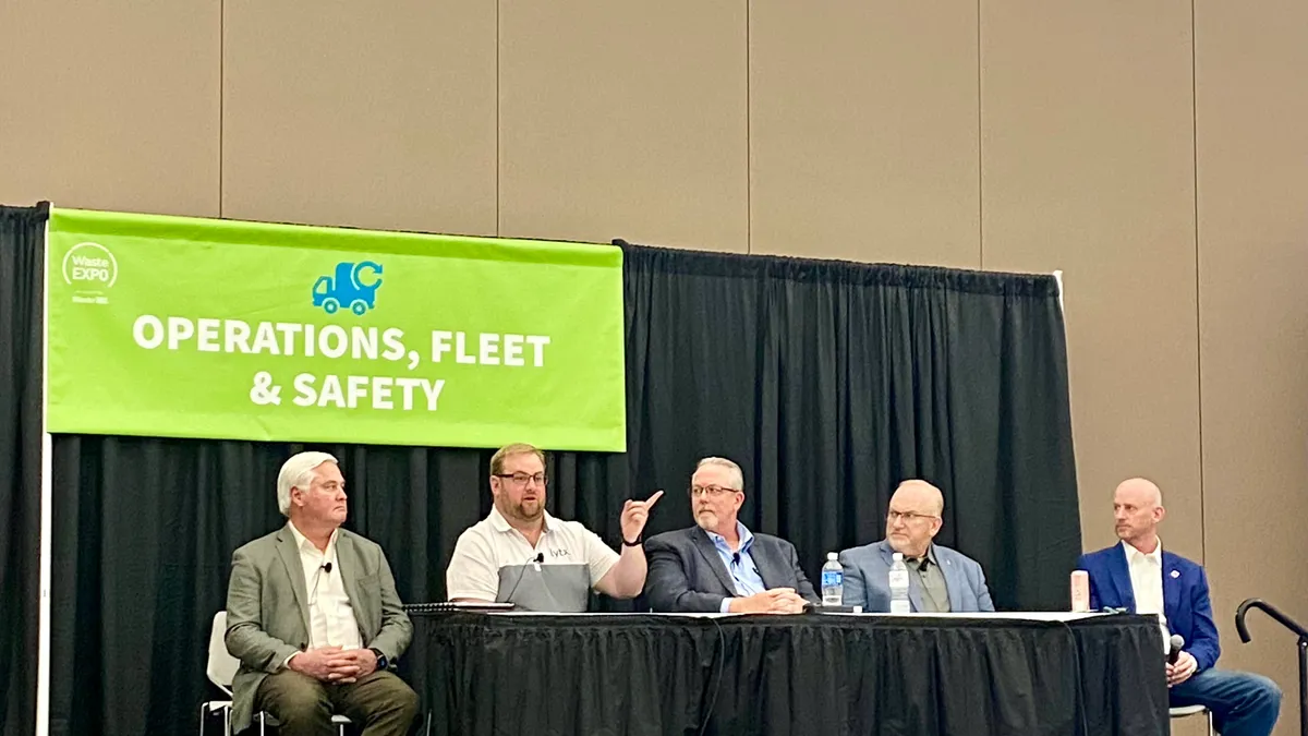 safety managers sit at a table during a presentation