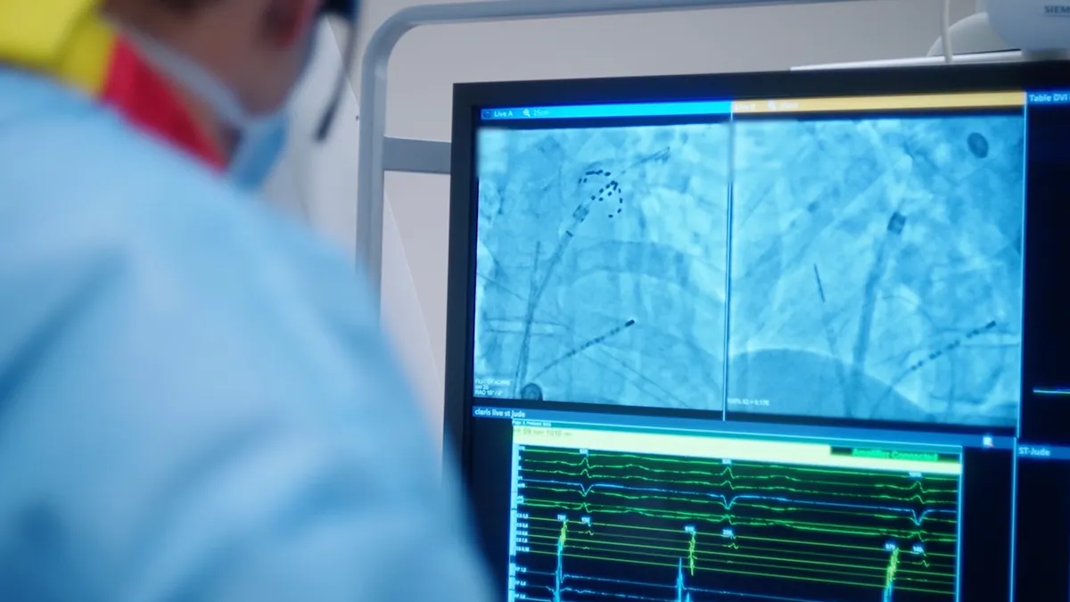 A picture of a doctor looking at an X-ray screen during a procedure.