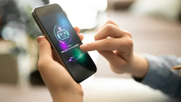 Woman uses smartphone chatbot.