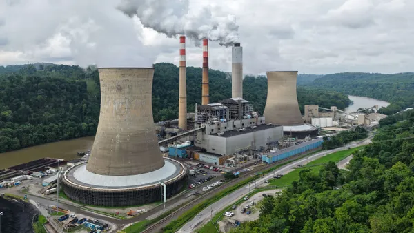 An aerial view of a power plant on a bend in a river.