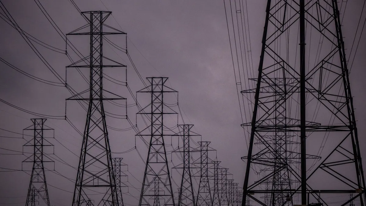 Transmission towers against a dark sky