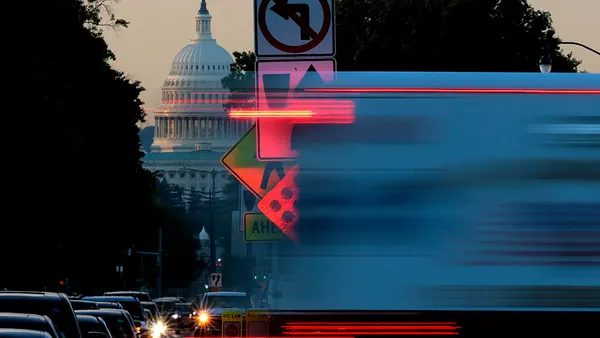 Morning traffic passes in front of the U.S. Capitol on Oct. 1, 2025 in Washington.