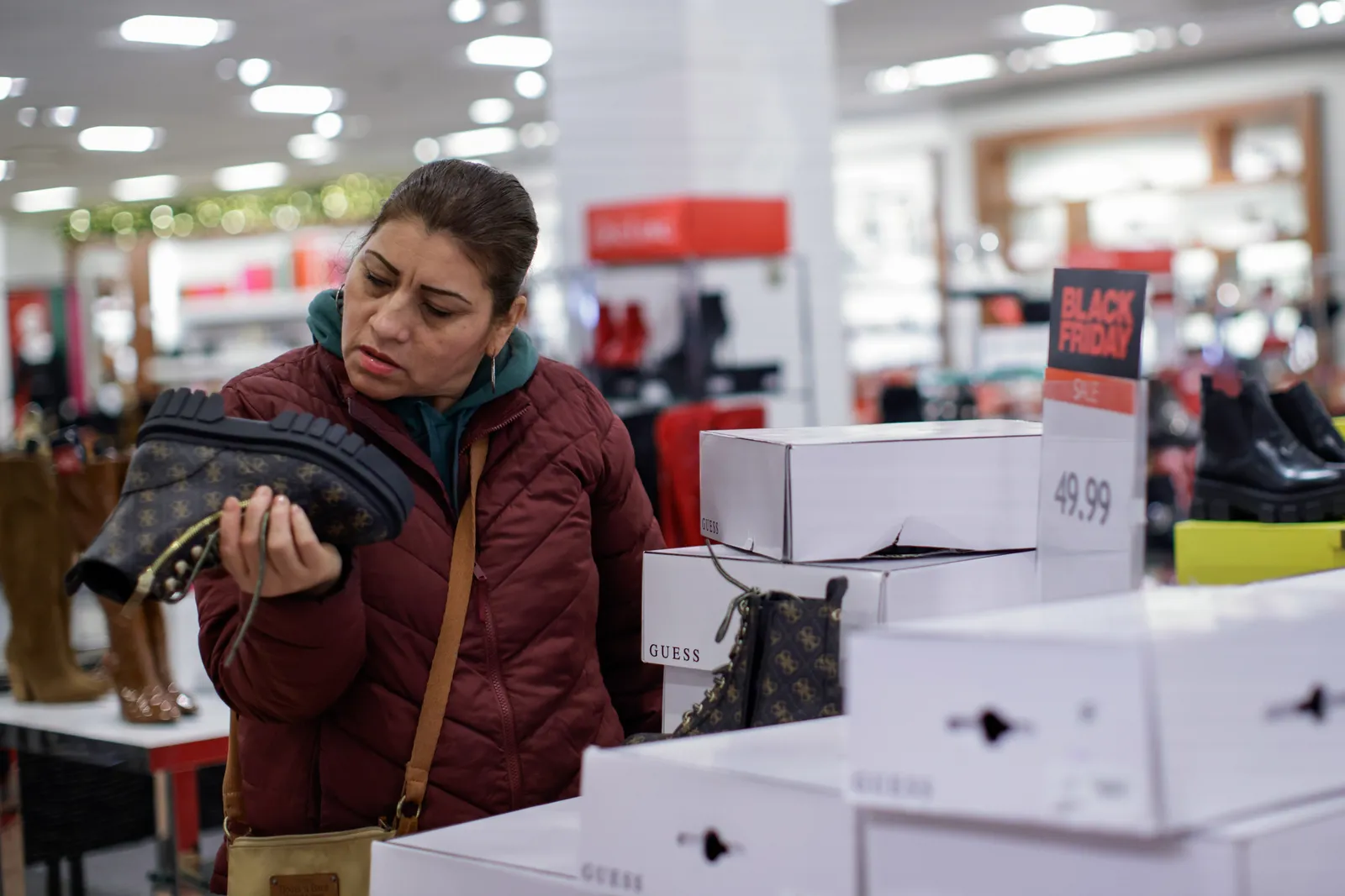 A person looks at the bottom of a shoe in a Macy's department store.