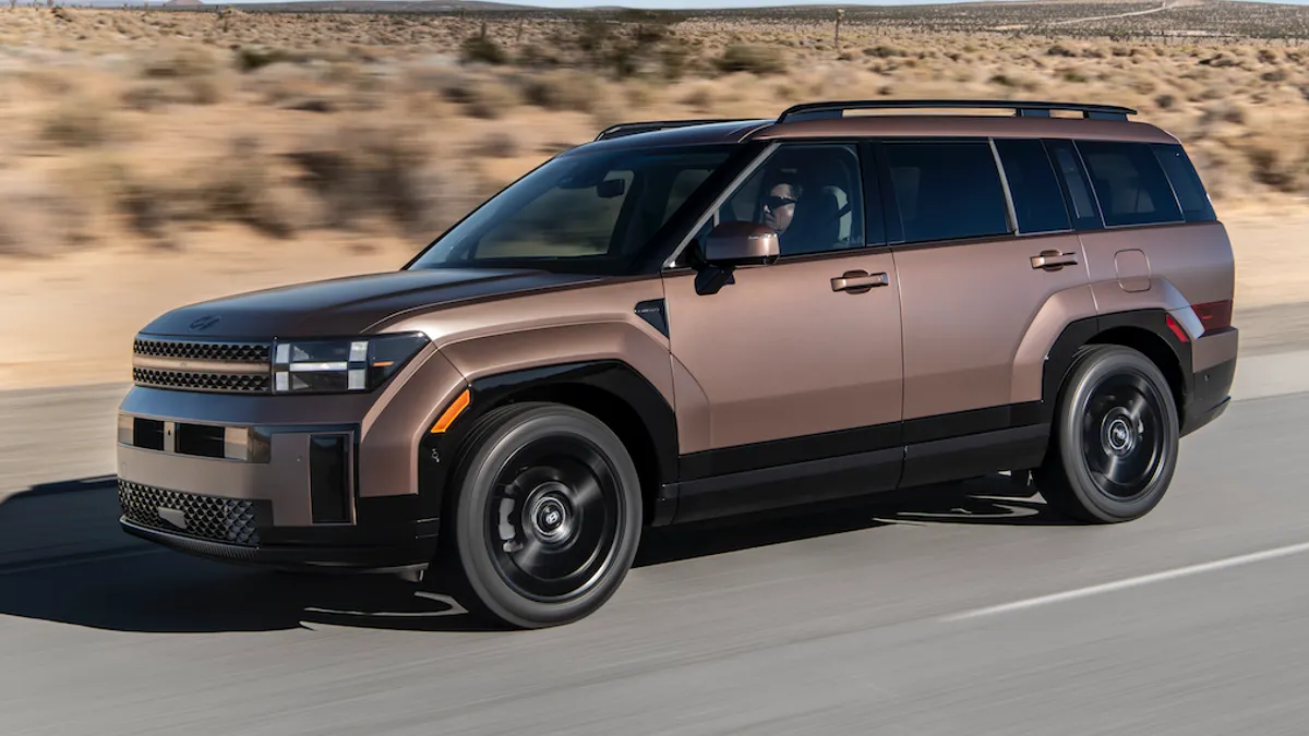 A 2026 Hyundai Santa Fe Hybrid SUV driving on a road.