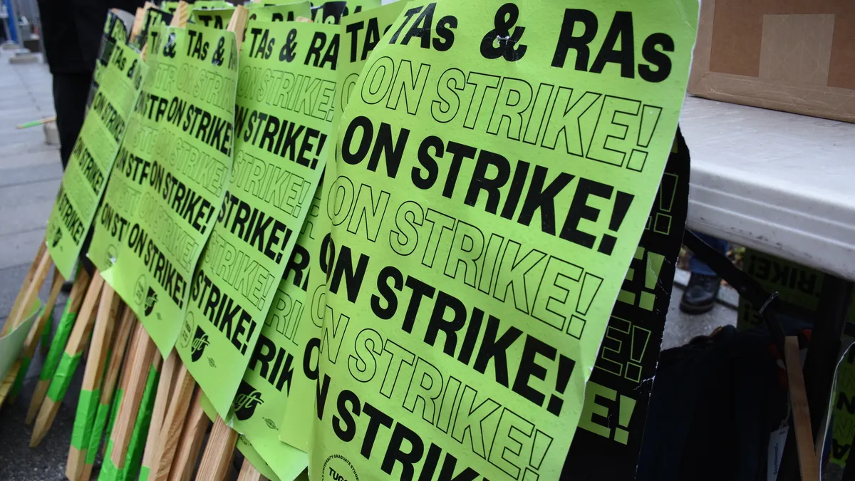 Rows of protest signs for Temple University graduate students' strike.