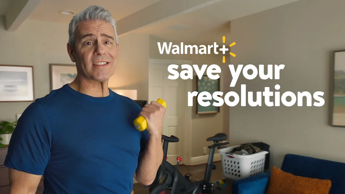 Andy Cohen holds a hand weight in a Walmart ad