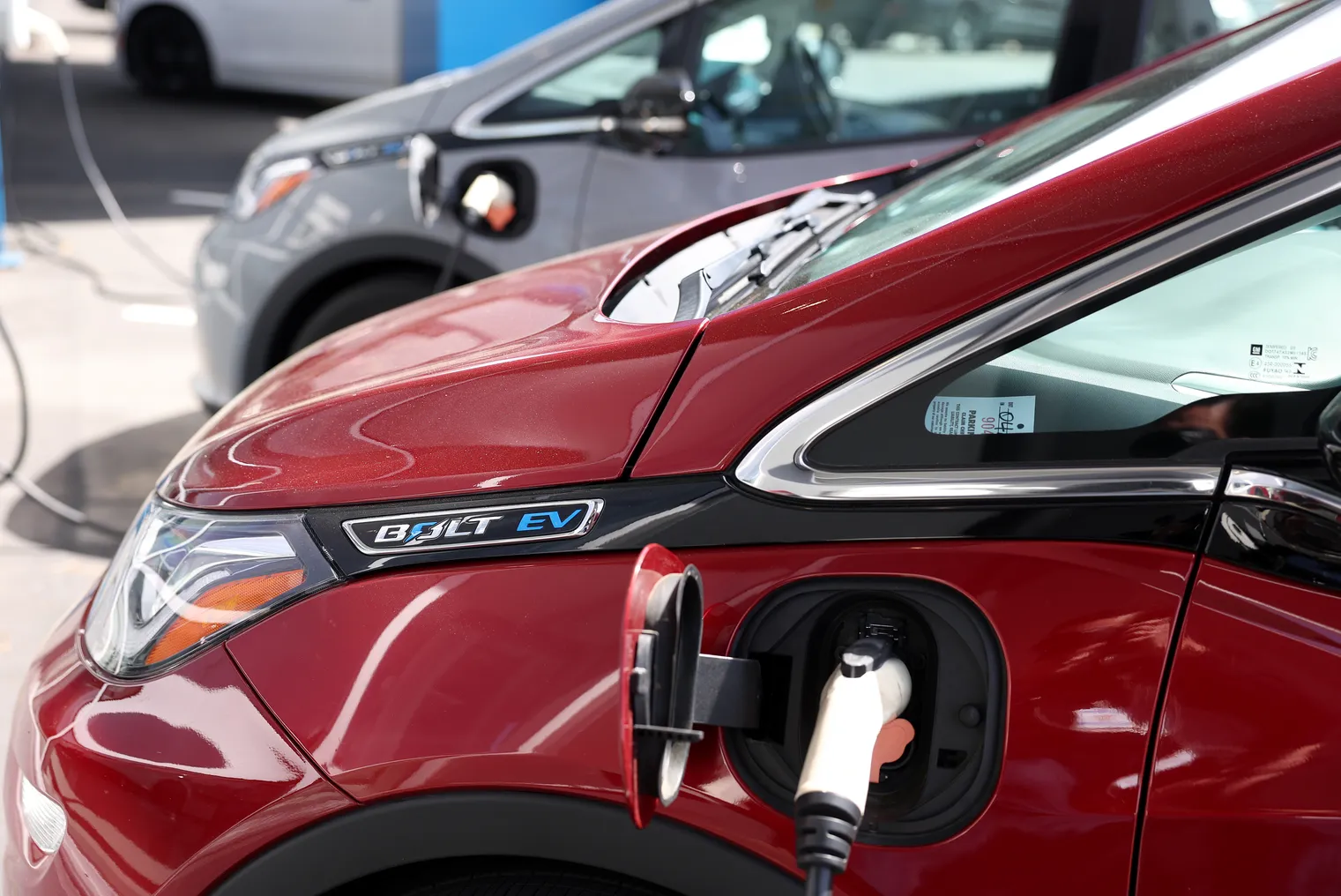 A Chevy Bolt EV plugged in at a charging station.