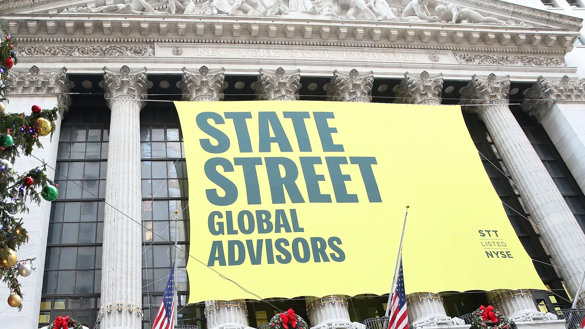 State Street building. Yellow banners say "State Street Global Advisors" "Reinventing Investing"