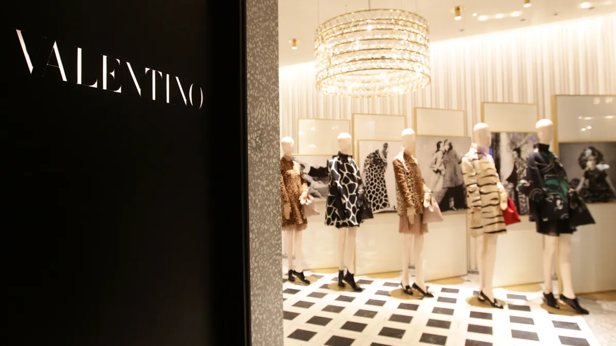 A Valentino store is pictured, showing the sign and mannequins.