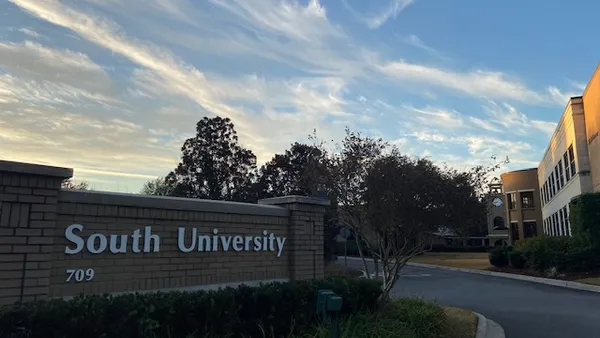 South University campus sign against sunset.