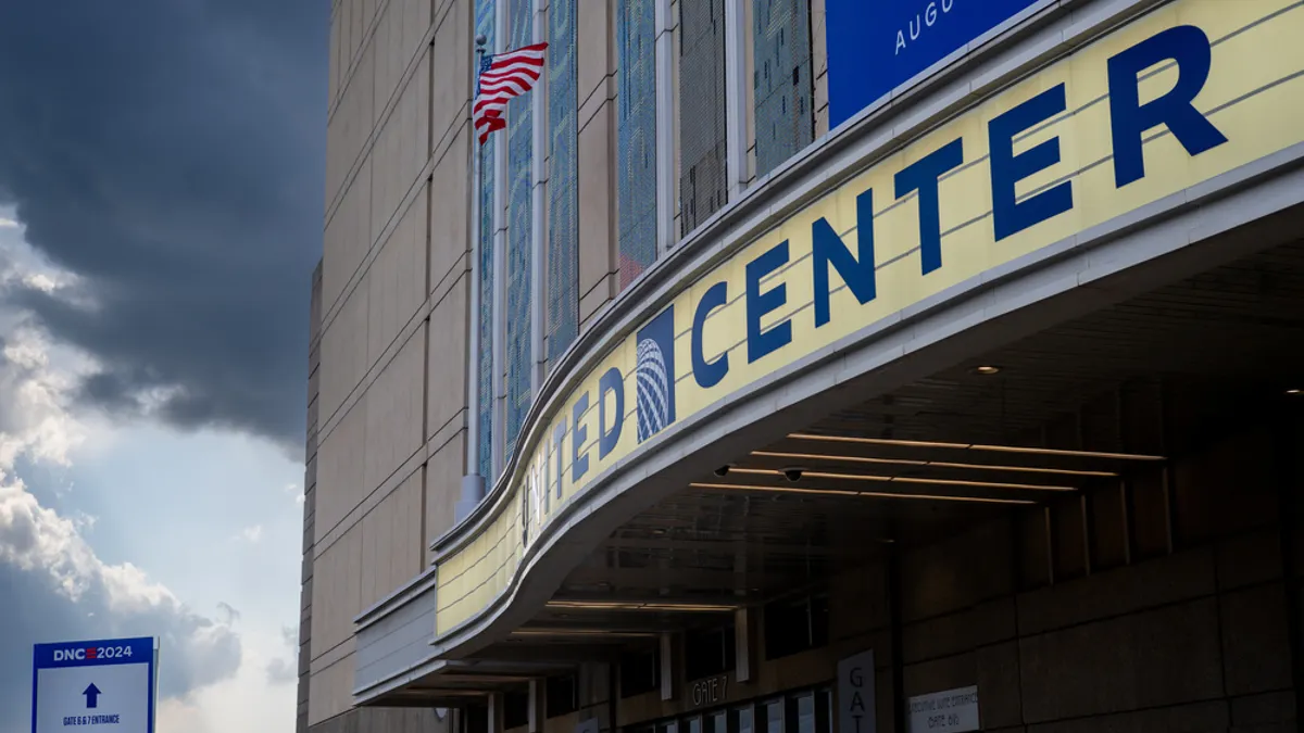 An exterior shot of a tall building with the words "United" on the front, bearing the logo of the airline.