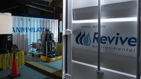 Two shipping containers with waste technology, one says Annihilator and another says Revive Environmental