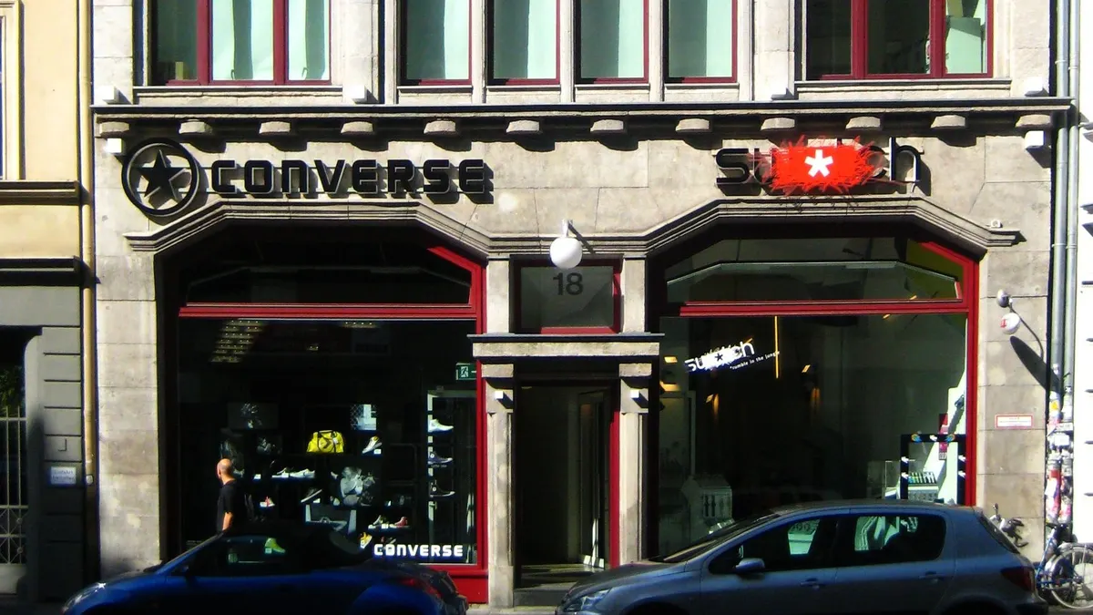 A stone building with a Converse storefront on the street level.