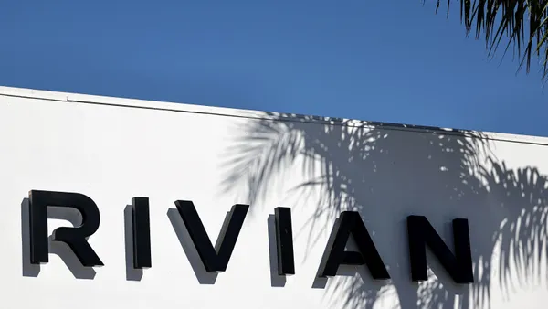 The word "Rivian" printed on the exterior of a building.