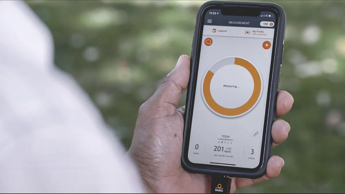 A person receives a blood glucose reading through DarioHealth's smartphone app