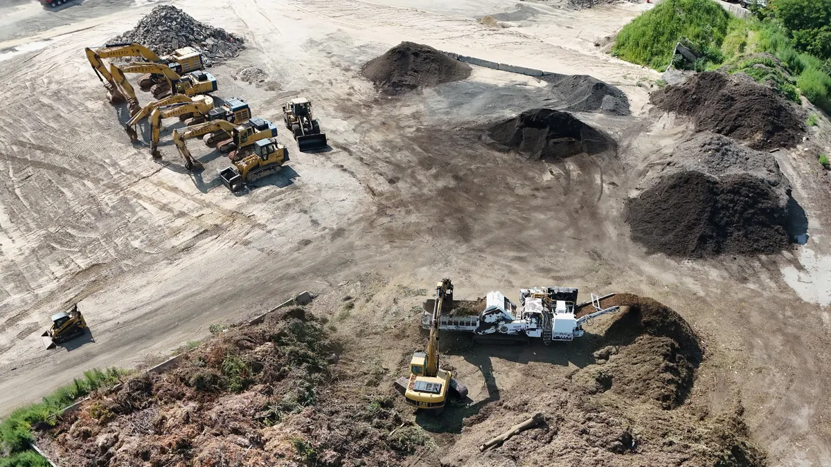 Aerial view of construction vehicles moving materials