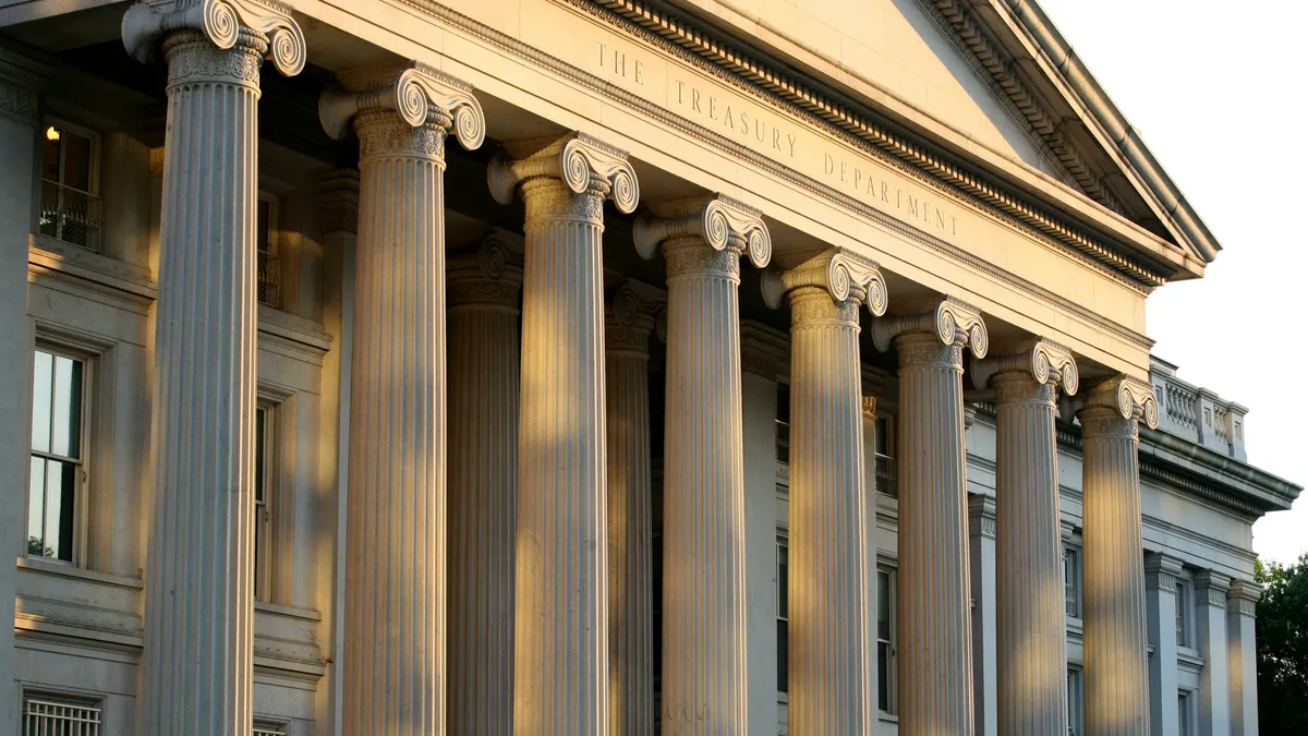 The sun sets on the facade of the U.S. Treasury Department.