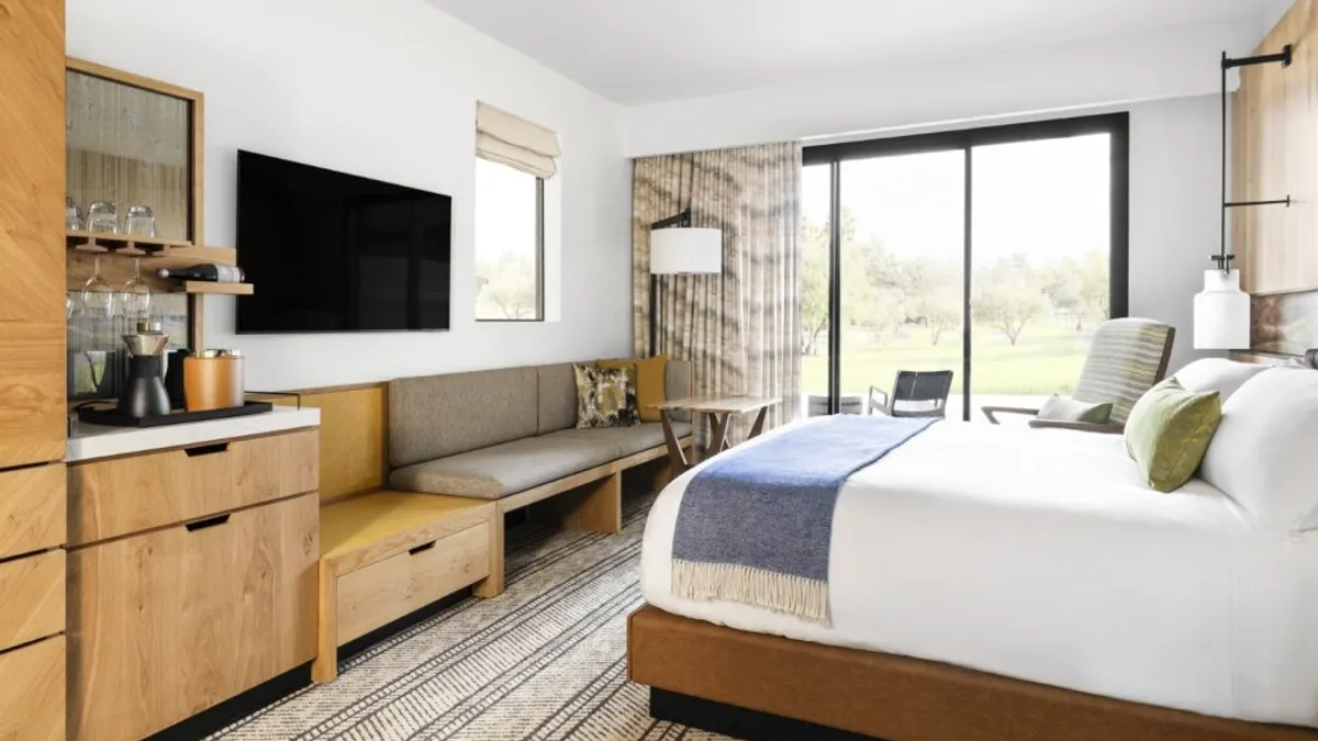 A bed in a hotel room.