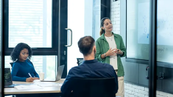 Use the Business Performance Management tool to Identify Market Trends and Demands. Business development manager on a performance review meeting with their team in a modern business office.