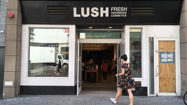 Woman walks into the Lush Handmade Cosmetics store on 6th Avenue in Manhattan.