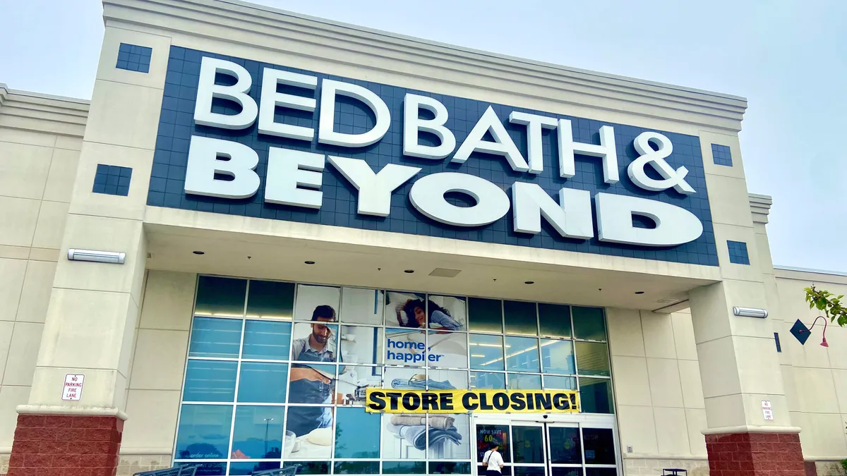 A Bed Bath & Beyond location with a "store closing" sign taped across the storefront.