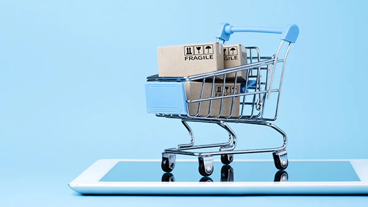 Illustration of shipping boxes in a shopping trolley on top of tablet with blue background