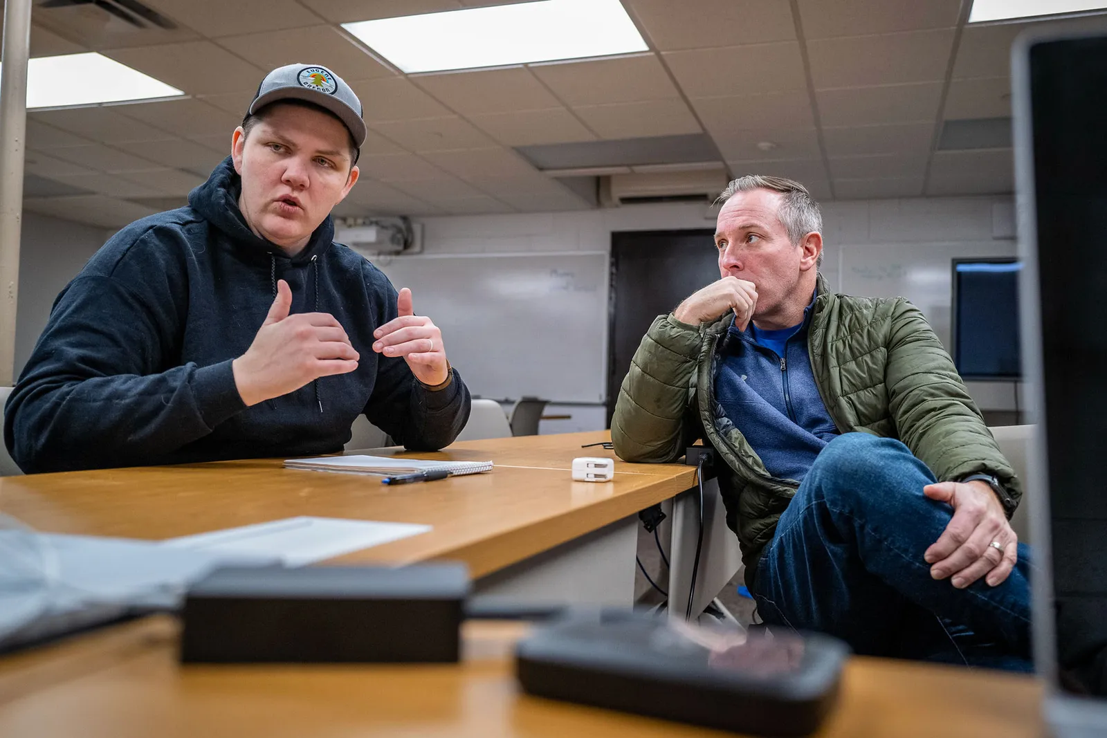 Two school district staff members are shown seated at a desk during a meeting about a January 2023 ransomware attack on Des Moines Public Schools in Iowa.