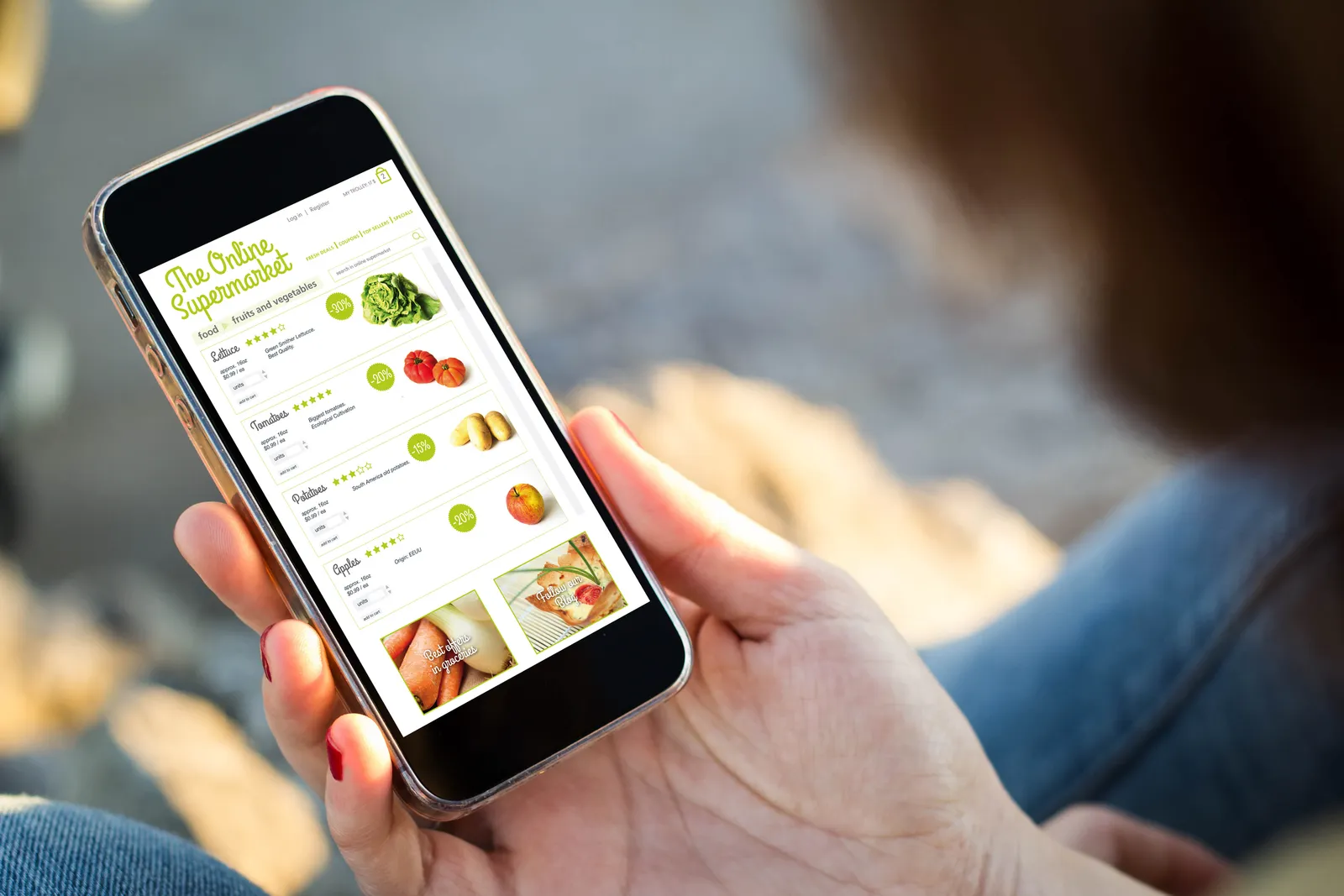 A hand holding a phone with grocery ordering on the screen.